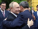 Russian President Vladimir Putin (left) and Vietnamese President To Lam embrace during an official welcome ceremony at the Presidential Palace, in Hanoi, Thursday.