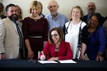 Gov. Kate Brown signs Senate Bill 1008 into law at the June Key Delta Community Center in Portland, Ore., Monday, July 22, 2019. The law brings reform to Oregon's juvenile justice system.