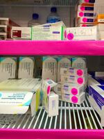 A refrigerator at Mid-Valley Children's Clinic in Albany, Ore., with supplies of government-funded vaccines for children on Medicaid. The pink "VFC" stickers help clinics follow stringent federal rules and ensure only eligible children get the "Vaccines for Children" shots.