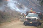 An engine crew from Grayback Forestry monitors a burnout operation on the Stouts Creek Fire.