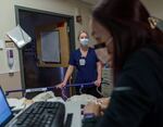 A patient is cared for in the hallway of the Salem Health emergency department in Salem, Ore., in January 2022. 