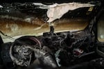 A burned truck that was attacked by Israeli settlers stands beside a road in the Palestinian village of Kafr Ni'ma in the occupied West Bank on March 24.