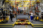 Employee work on a truck bed for the Ford F-150 Lightning at the Ford Rouge Electric Vehicle Center in Dearborn, Mich., on Sept. 7, 2022.