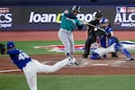 Seattle Mariners Jorge Polanco connects for an RBI single as Toronto Blue Jays pitcher Seranthony Domínguez (48) follows through during the eighth inning in Game 1 of baseball's American League Championship Series, Sunday, Oct. 12, 2025, in Toronto.