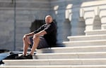 Sen. John Fetterman, D-Penn., sits on the steps of the U.S. Capitol on Oct. 1, the first full day of the government shutdown. "People are really just kind of dug in and everything is hyper-politicized," he said this week.