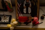 A high school graduation picture of Rafael, Nancy’s oldest son who attended middle school at Portland Public Schools’ Beaumont Middle School, is displayed next to a Virgin Mary candle at the family’s home at their home in Portland, Ore., on Dec. 2, 2025. The family is identifying by just first names out of safety concerns.