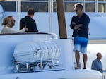 Lachlan Murdoch, right, with his wife Sarah and others as they watch a sailing regatta in Sydney, Australia in February.