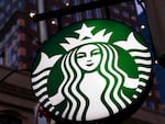 This June 26, 2019, photo shows a Starbucks sign outside a Starbucks coffee shop in downtown Pittsburgh.