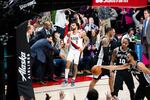 Coaches and fans react after Gary Trent (2) hits a three-pointer during a game between the Portland Trail Blazers and San Antonio Spurs on Thursday, Feb. 6, 2020. The game operations team will try to play music that carries energy from big plays or runs through timeouts.