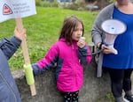 Miriam Van Zandt, center, a second grader at Buckman Elementary School in Portland, Ore., helps lead the chant "We love teachers,” to which the protesters called back, “We love students!”