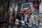 Souvenirs on display in a shop in Assisi include statues and holy cards of St. Francis and Carlo Acutis.