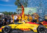 Alex Palou (10) stands on top of his winning car as he celebrates with his pit crew and team Sunday, Aug. 9, 2026, at Portland International Raceway.