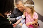 Simon Weaver holds his daughter, Vivian, while a nurse prepares to draw blood on Jan. 30, 2019. 