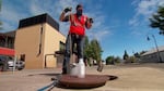 Jason Cook of Clean Water Services pulls a wastewater sample from a sewer in Forest Grove, Oregon. 