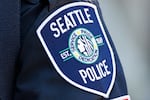 FILE - A Seattle Police Department patch is seen on an officer's uniform, July 17, 2016, in Seattle. The Washington Supreme Court heard arguments Tuesday, June 25, 2024 in a case that will decide whether the names of four Seattle police officers who attended events in the nation’s capital on the day of the insurrection are protected under the state's public records law.