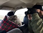 Todd Stansbery, right, and Zach Slick watch the raven traps they just set. They are helping out with research looking into how ravens are affecting sage grouse near Baker City, Oregon.