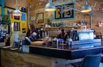 From left, Leithan Gillespie and Dani Huard work their barista shifts at Turtle Island Coffee Shop in Bend, Ore., on Jun., 7, 2024.