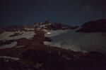 After midnight the team hikes up the glacier to survey the Cerberus moulin, lighting it up with their headlamps.
