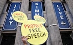 A demonstrator waves a "Protect Free Speech" sign following a protest against the suspension of the "Jimmy Kimmel Live!" show, held near the theater where the show is produced in Hollywood, on September 22, 2025 in Los Angeles, California.