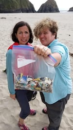 OPB reporters Cassandra Profita and Jes Burns with plastic found on an Oregon beach.  Some plastic that ends up here likely entered the ocean via river.