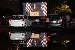 Democratic vice presidential nominee Kamala Harris speaks during the Democratic National Convention, as seen on a screen at a drive-in watch party for the convention at Suffolk Downs, Wednesday, Aug. 19, 2020, in Boston. 