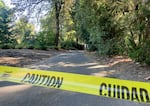 Caution tape surrounds the area around Lewis & Clark College’s swimming pool on Aug. 30, 2022. One student died and two were injured Monday night when a free-standing column collapsed. Investigators learned that several hammocks were attached to the column when it collapsed.