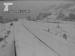 A traffic cam screen shot shows a road blanketed in snow.