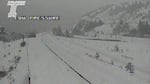 A traffic cam screen shot shows a road blanketed in snow.