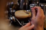 Daniel Gonzalez makes a Café de Olla at Providencia in NE Washington, D.C., on Thursday, December 12, 2024. This alcoholic cocktail contains rum, coffee, sesame, and horchata and is served with a piece of packaged Kopiko coffee candy.