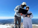 Diego Caporale, left, and Yifeng Zhang, both of the University of Southern California, work on getting Spirit to walk up the snowy and rocky areas of Mount Hood.