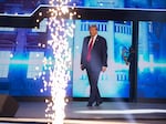 Former President Donald Trump walks on to the stage to give the keynote address at Turning Point Action's "The People's Convention" on Saturday in Detroit, Michigan.