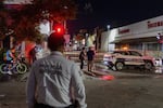 Policeman stands near a convenience store destroyed by a fire in Hermosillo, Sonora state, Mexico, Saturday, Nov. 1, 2025. (