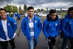 Hector Capetillo (second from left) and Yobeli Manzo walk through the parking lot of Summit High School in Bend, Oregon.