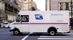 A U.S. Postal Service truck drives in Philadelphia. The service is about to set longer delivery standards for first-class packages, in a move that its regulator says will not have a big effect on its finances.