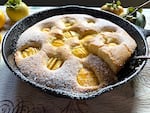 A sunken persimmon cake baked in the style of traditional German "Versunken Apfelkuchen," meaning a sunken apple cake.