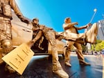 A piece from the Trump Statue Initiative depicts federal law enforcement officers pulling a Black Lives Matter protester into an unmarked van while the President takes a selfie.