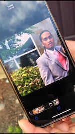 A family friend holds a photo of Kfin Karuo, 28, at a wedding in 2014. Family members identified Karuo as the man shot and killed by Clark County deputies on Oct. 17.
