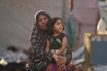 Palestinians look at the damage after an Israeli strike hit a tent area in the courtyard of Al Aqsa Martyrs hospital in Deir al Balah, Gaza Strip, Monday, Oct. 14, 2024.