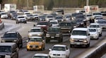 FILE - Traffic moves along Highway 26 heading into Portland, Ore., on Dec. 16, 2016.