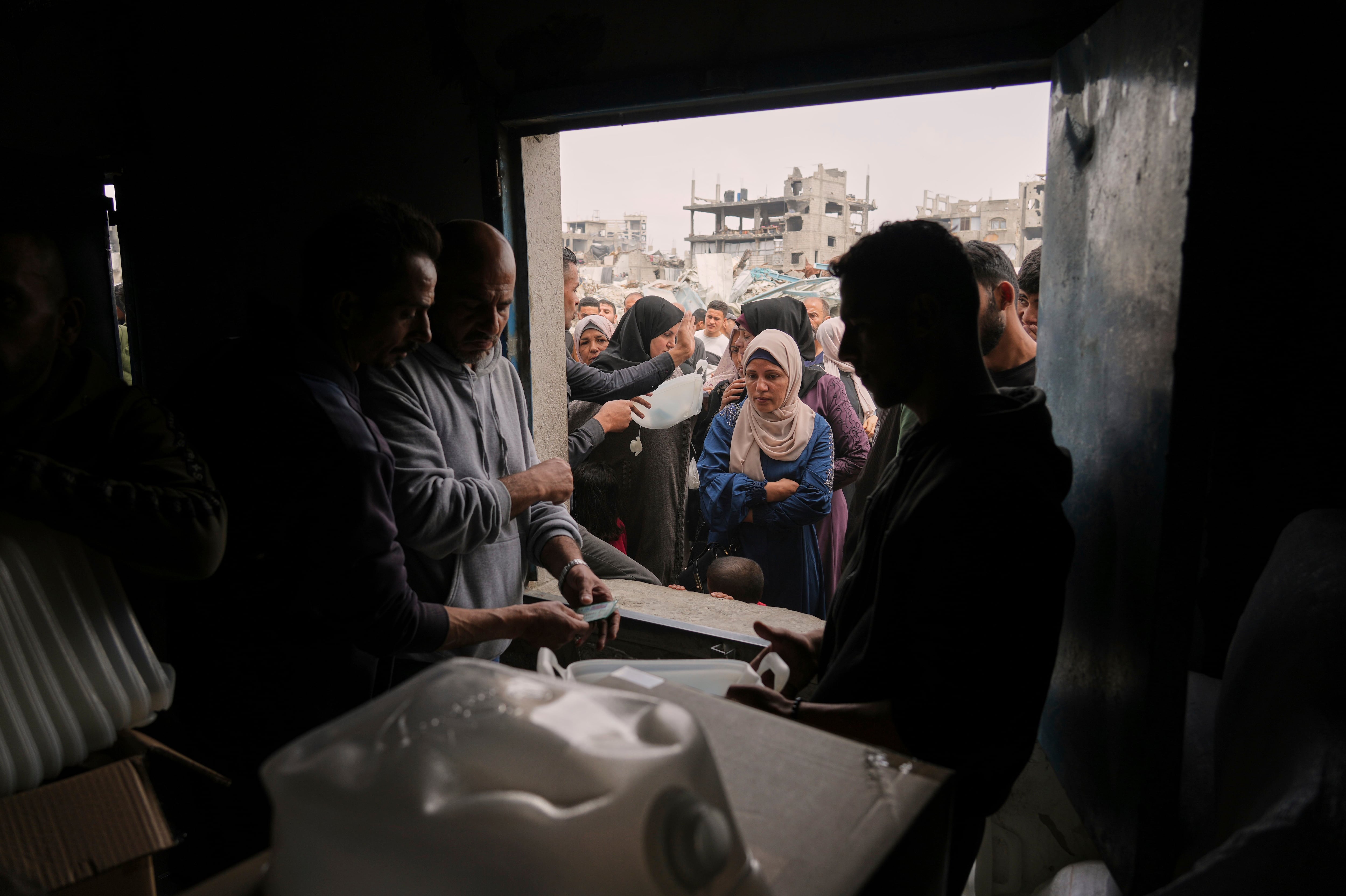 Palestinians receive humanitarian aid distributed by UNRWA, the U.N. agency helping Palestinian refugees in Jabaliya, Gaza Strip on Wednesday, April 9, 2025.