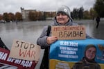 Victoria Yakhno holds a banner showing her missing son, Maksym Yakhno, during a demonstration on the main square in Pavlohrad, Ukraine, on Oct. 19. The relatives of missing and imprisoned soldiers line streets across Ukraine, usually on weekends, to draw attention to their missing loved ones. Pavlohrad is part of a chain of mining centers along a highway stretching east from the Donbas region.