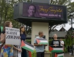 Protesters gathered outside of the Hult Center in Eugene, Ore., on Aug. 15, 2025.