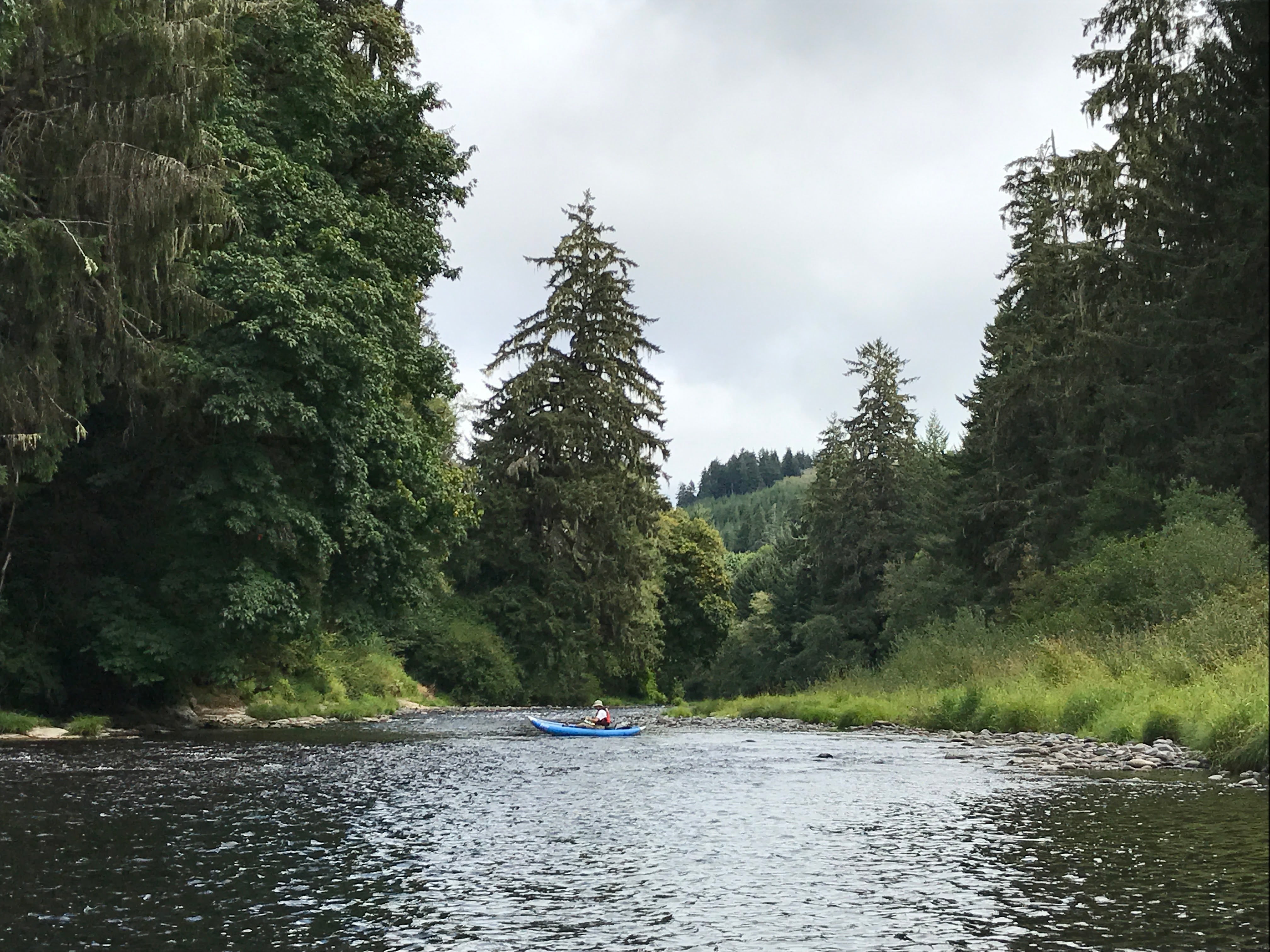 FILE: A kayaker maps part of the Siletz River in Lincoln County, Ore., in 2017.