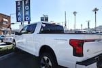 A Ford F-150 Lightning electric pickup truck is displayed for sale at a Ford dealership in Glendale, Calif., in August. Some car shoppers are hurrying to finalize EV purchases while they can still be certain to get a hefty federal tax incentive.