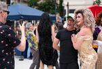 Joey Klei takes a photo of Bruce Ross with drag artist Bolivia Carmichaels.