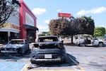 Charred vehicles sit in a parking lot sit outside a shopping mall in Guadalajara, Jalisco state, Mexico, Sunday, Feb. 22, 2026, as authorities reported the Mexican Army killed Jalisco New Generation Cartel leader Nemesio Oseguera, known as "El Mencho.
