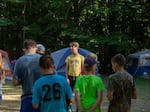 A druh, or male counselor to the older campers, calls his campers over to line up for the next activity.