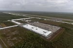 In an aerial view from a helicopter, the migrant detention center, dubbed "Alligator Alcatraz," is seen located at the site of the Dade-Collier Training and Transition Airport on July 4, 2025 in Ochopee, Fla. The 5,000-bed facility is located at a rarely-used airfield in the Everglades wetlands, as part of the Trump administration's expansion of undocumented migrant deportations.