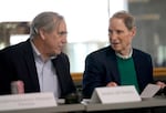 U.S. Sens. Jeff Merkley, left, and Ron Wyden confer during a town hall held at the Federal Building in Portland, Ore., March 17, 2025. The event aimed to provide an opportunity for federal employees to talk about the impact of layoffs in the federal government.