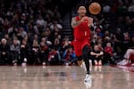Portland Trail Blazers guard Anfernee Simons passes the ball against the Detroit Pistons during the first half of an NBA basketball game Thursday, Feb. 8, 2024, in Portland, Ore.